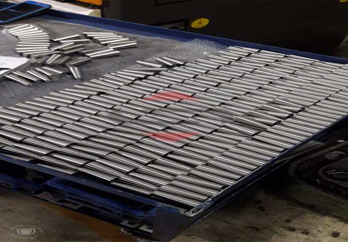 A Blue Crate With Metal Products On It